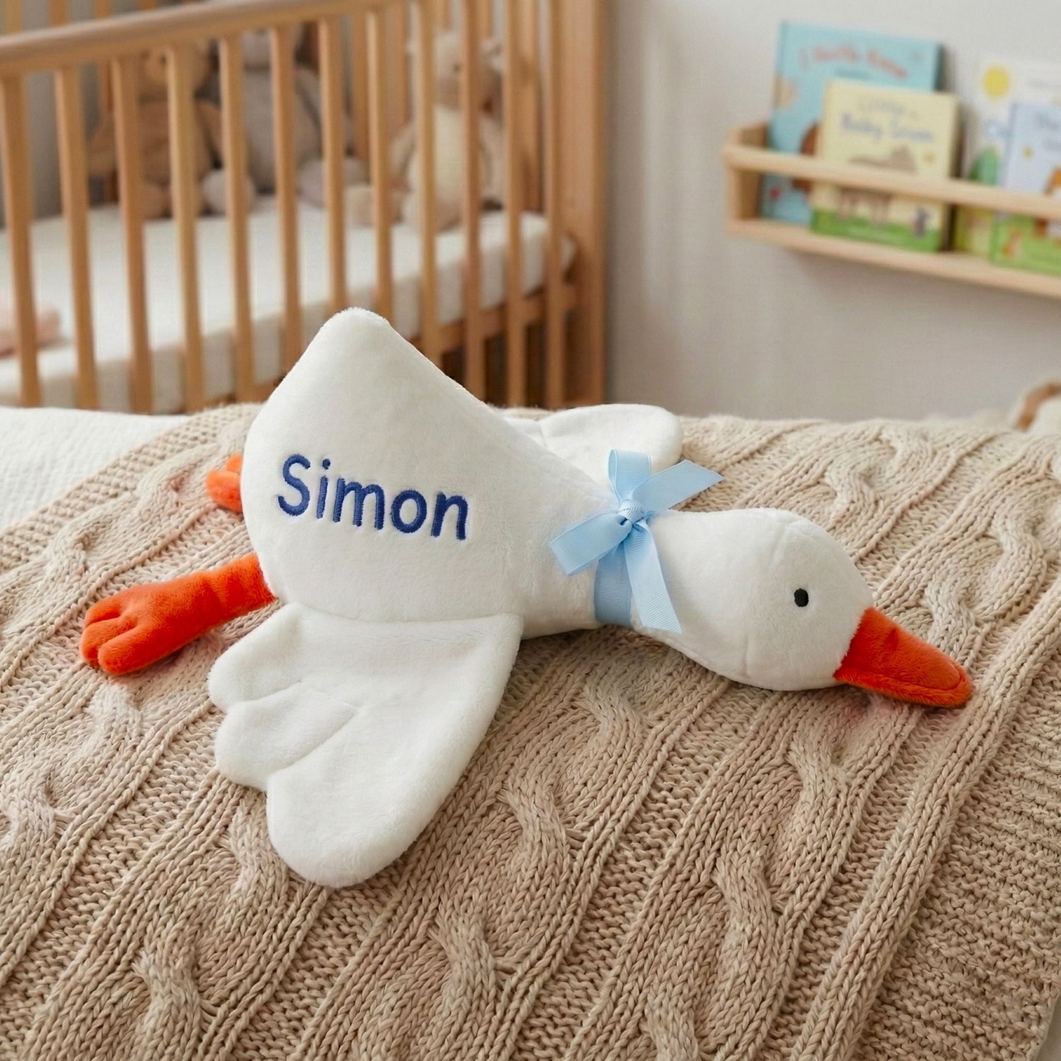 A collection of handmade personalized plush toys and custom embroidered animal pillows for nursery decor.
