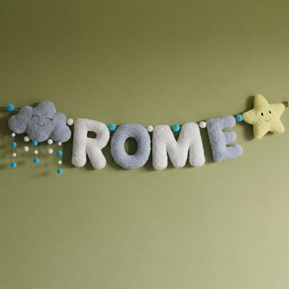 Felt letter banner with decorative elements on a green background