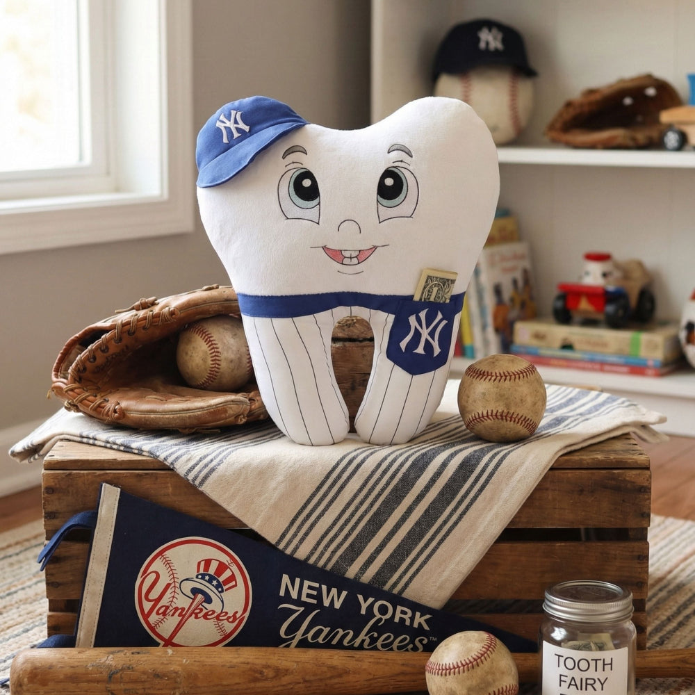 Plush tooth with New York Yankees cap on a wooden crate with sports-themed decor.