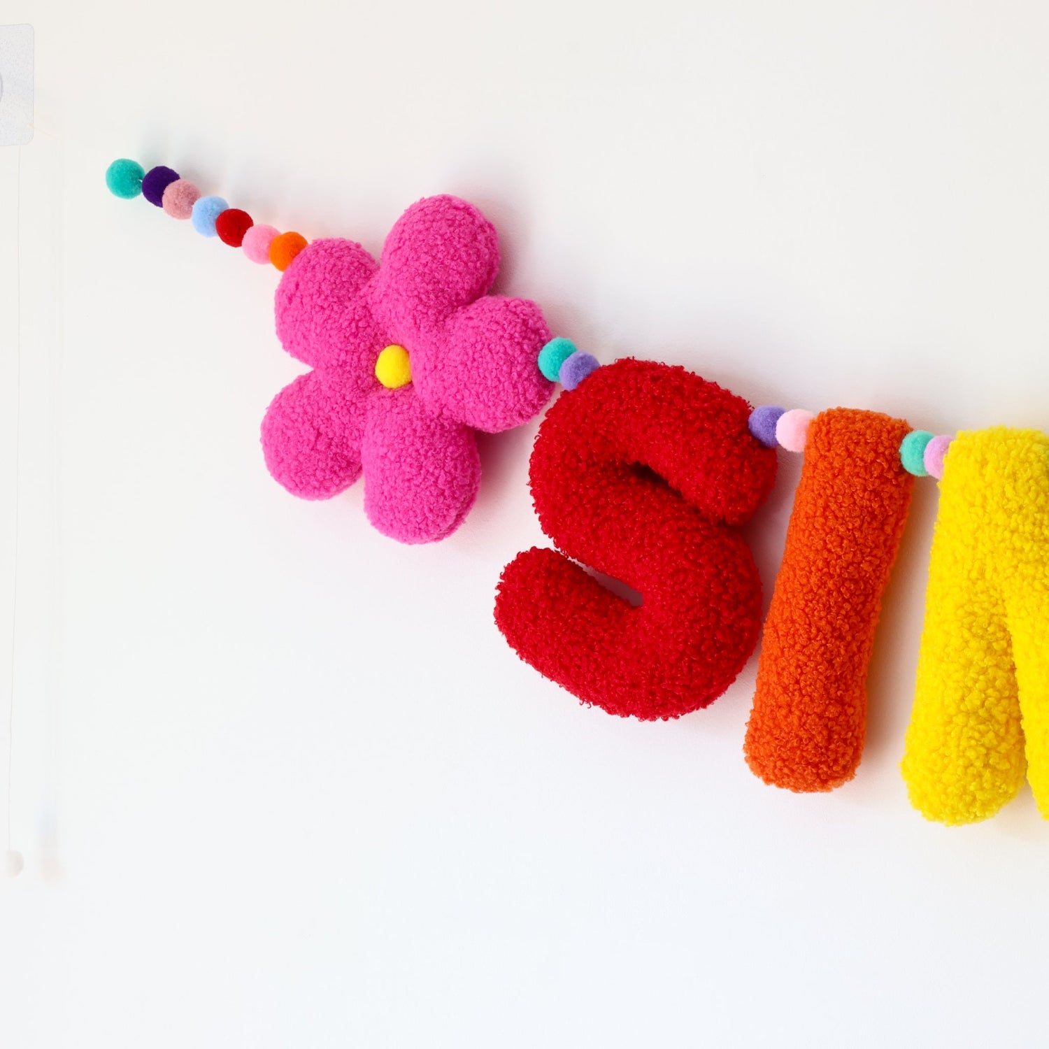 Colorful letter-shaped toys spelling  on a white background
