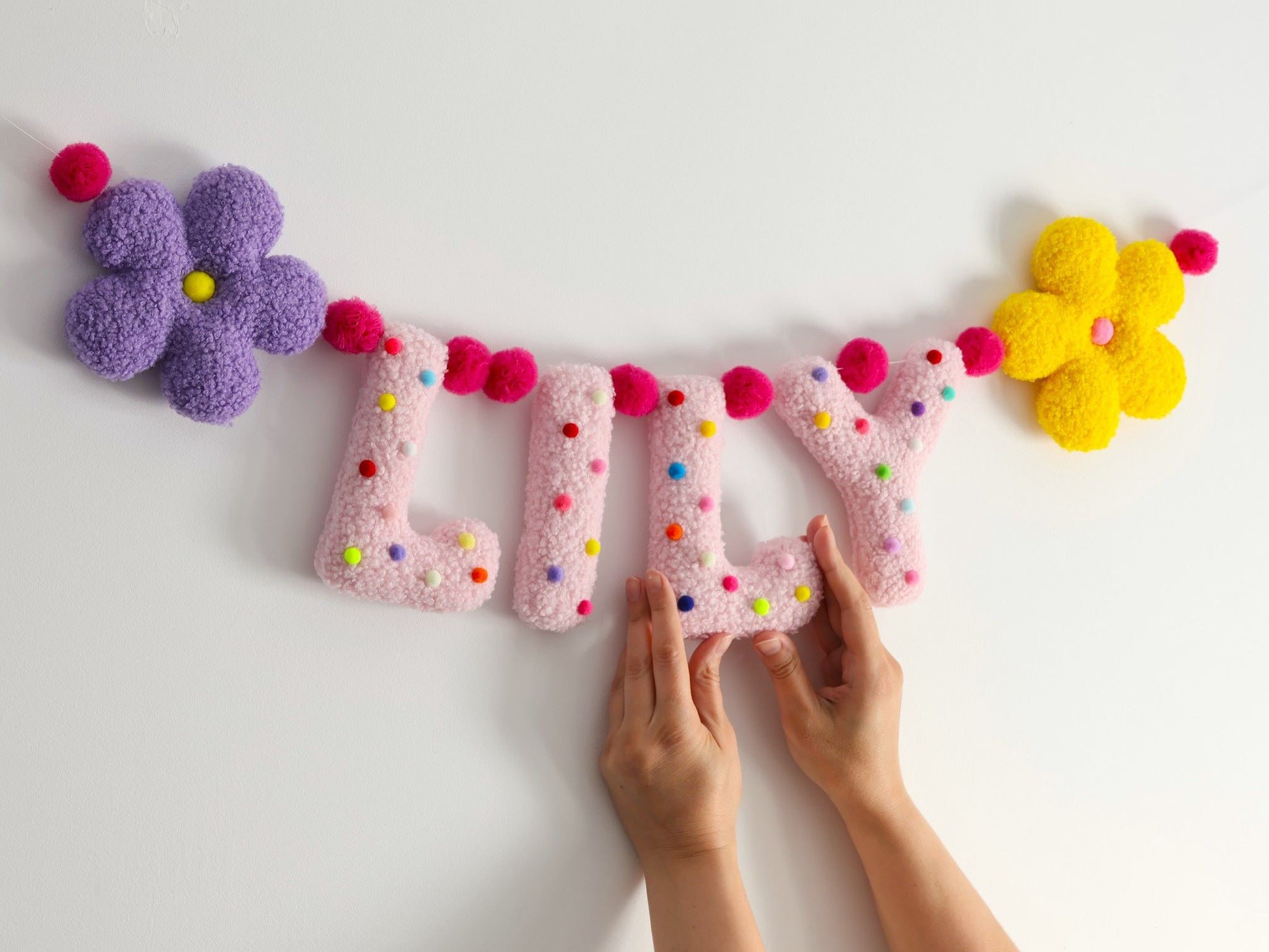Decorative banner with colorful letters and flowers on a white background