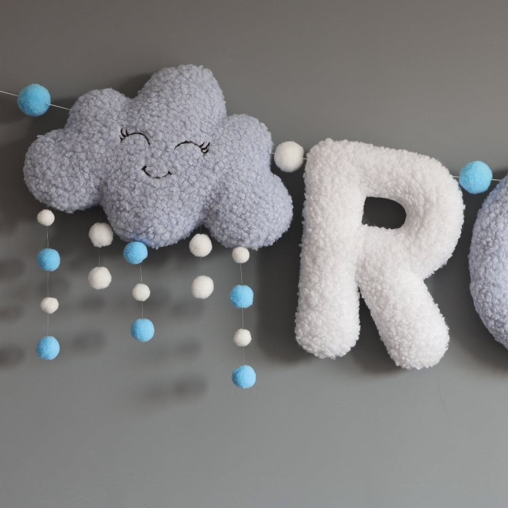 Decorative cloud and letter 'R' with colorful balls on a gray background