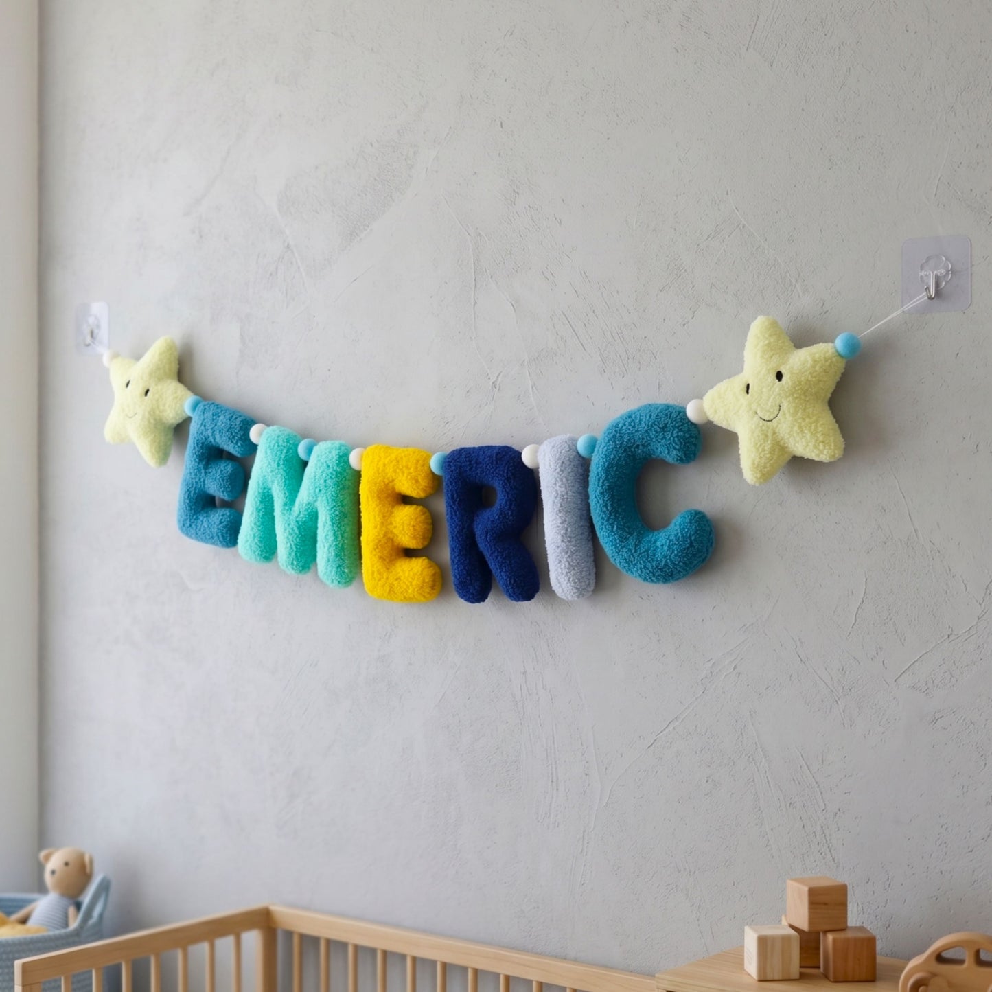 Colorful name banner with stars hanging on a wall in a nursery.