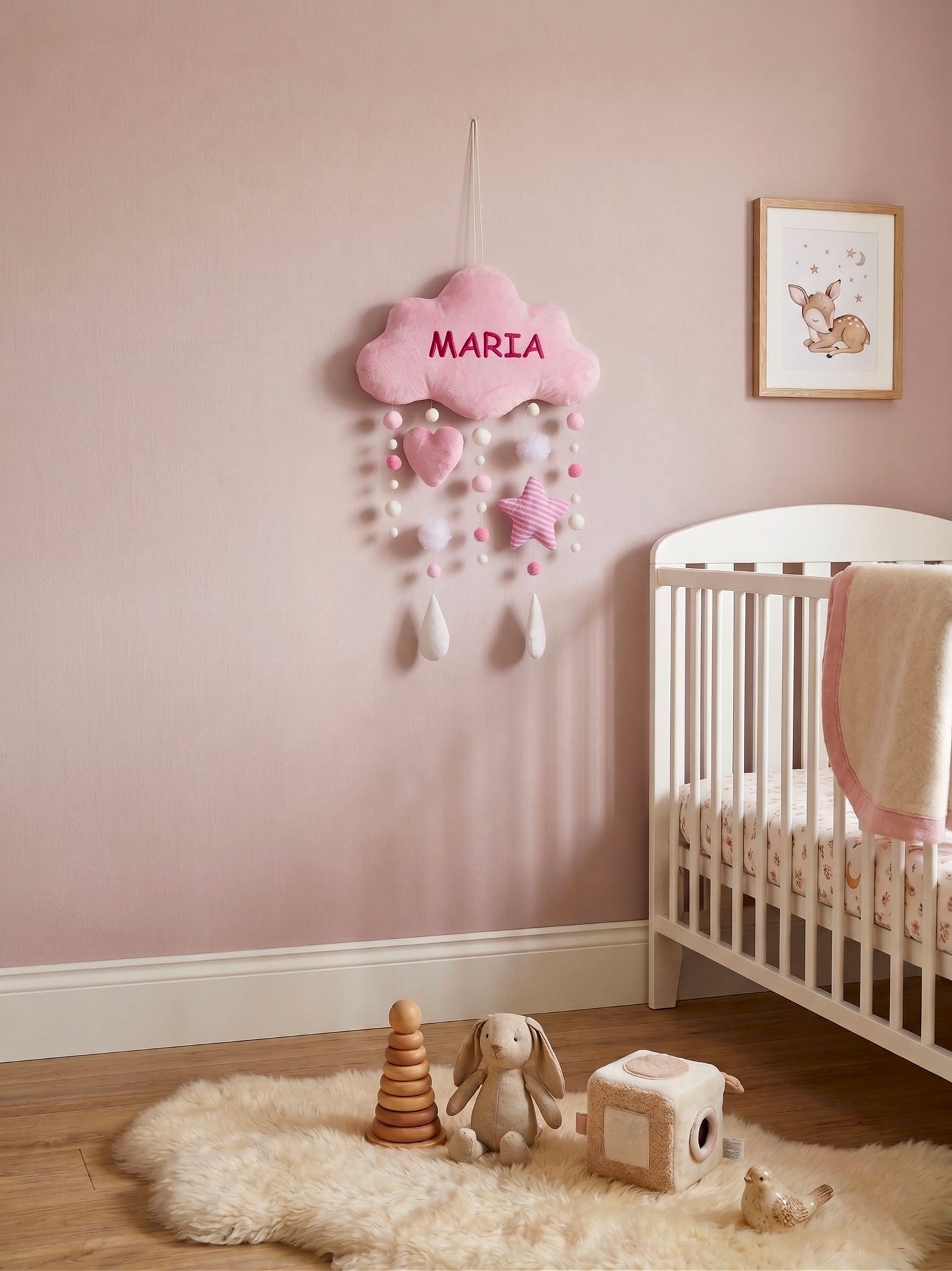 Children's room with pink cloud decoration, crib, and toys on a light pink wall.