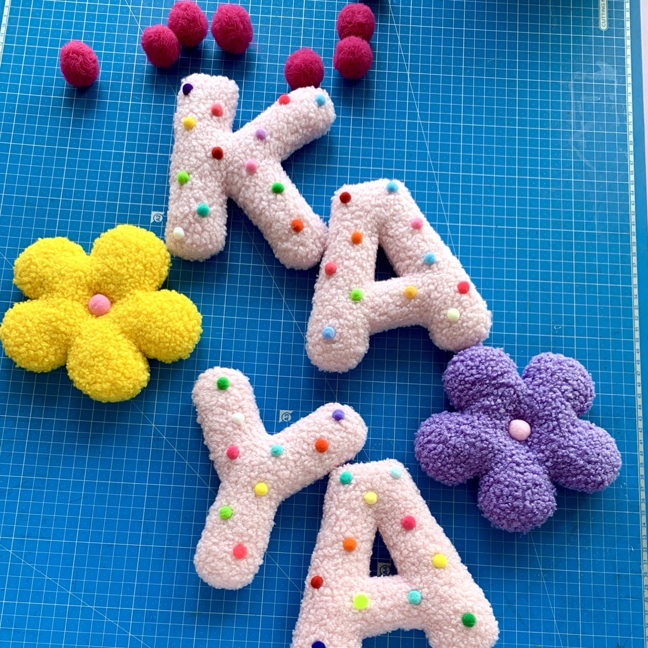 Decorative letters with colorful polka dots on a blue grid background