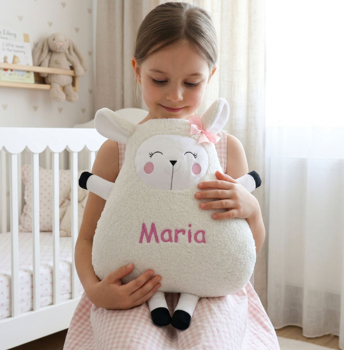 Child holding a plush sheep toy named 'Maria' in a nursery setting