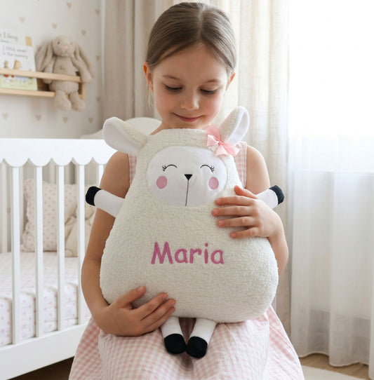 Child holding a plush sheep toy named 'Maria' in a nursery setting