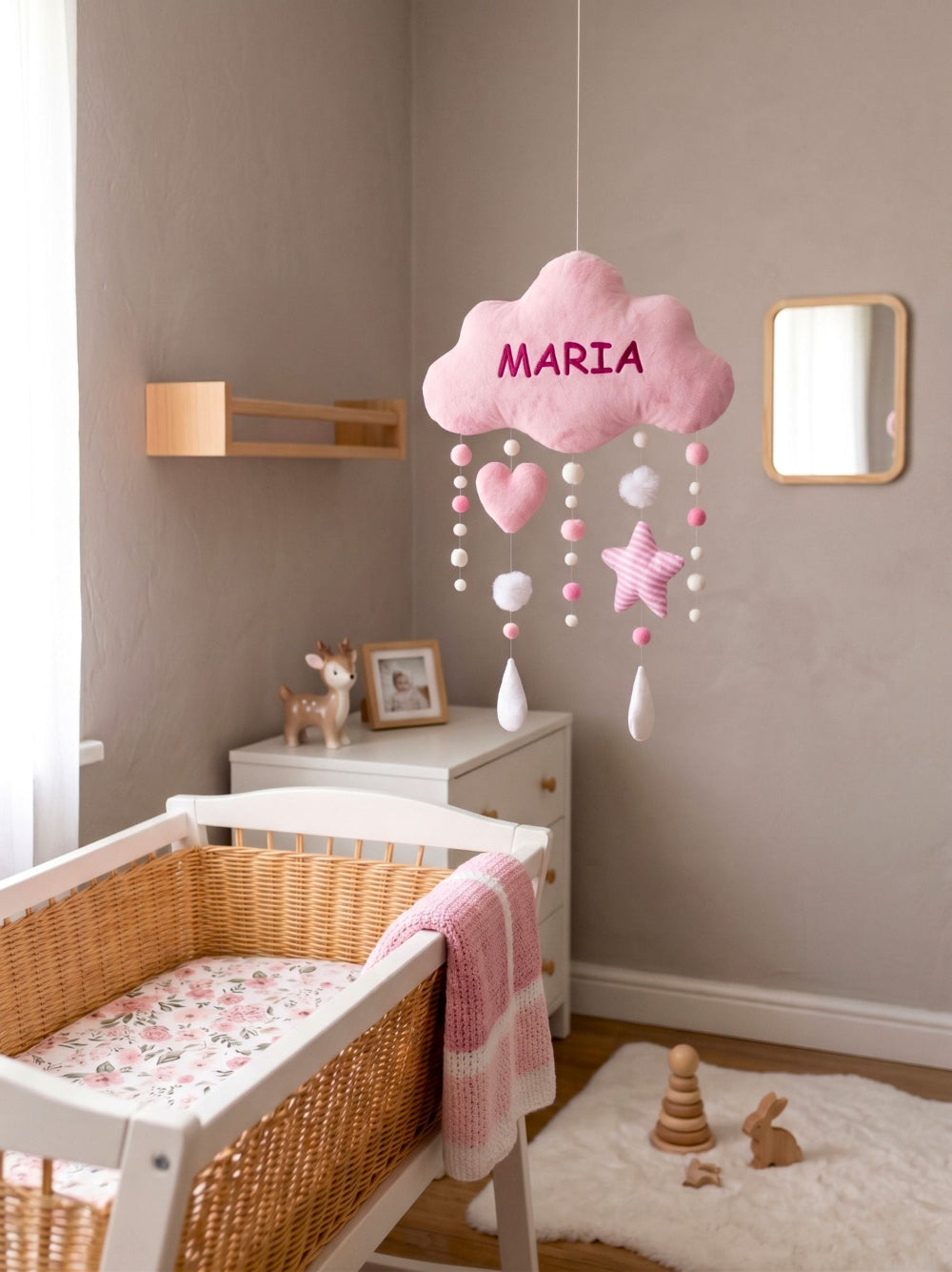 Nursery room with a crib, cloud-shaped baby mobile, and decorative items