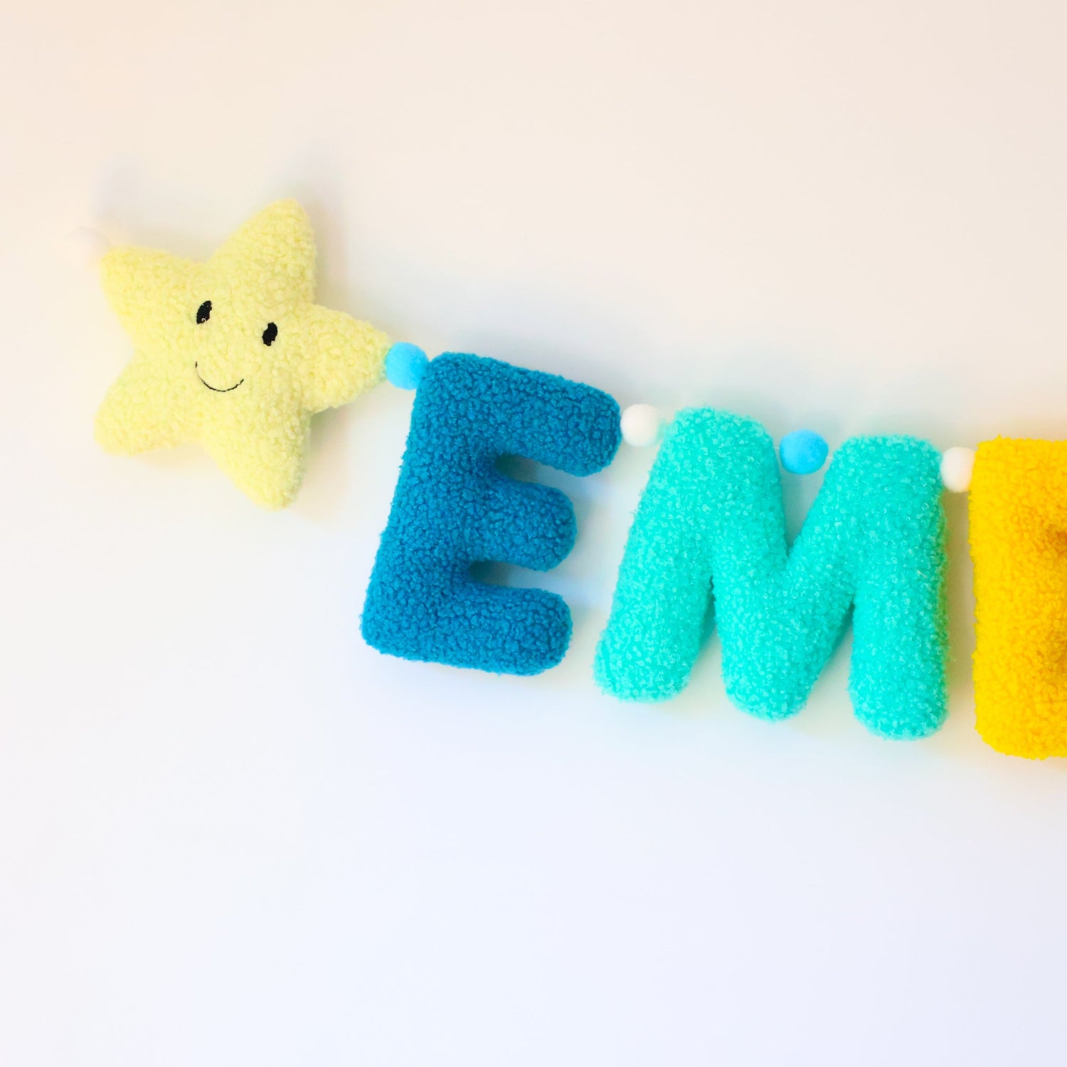 Colorful letter garland with a star on a white background